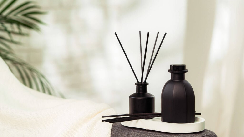black reed diffuser and black bottle of essential oil