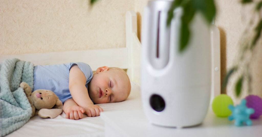 baby sleeping with humidifier in the room