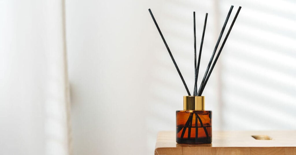 15 Best Reed Diffusers for Bathroom: A Buying Guide 11 reed diffuser in a wooden shelf