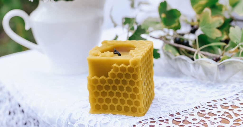 The 10 Healthiest Ways to Fragrance Your Home: A 2026 Guide 38 beeswax candle in a wooden table