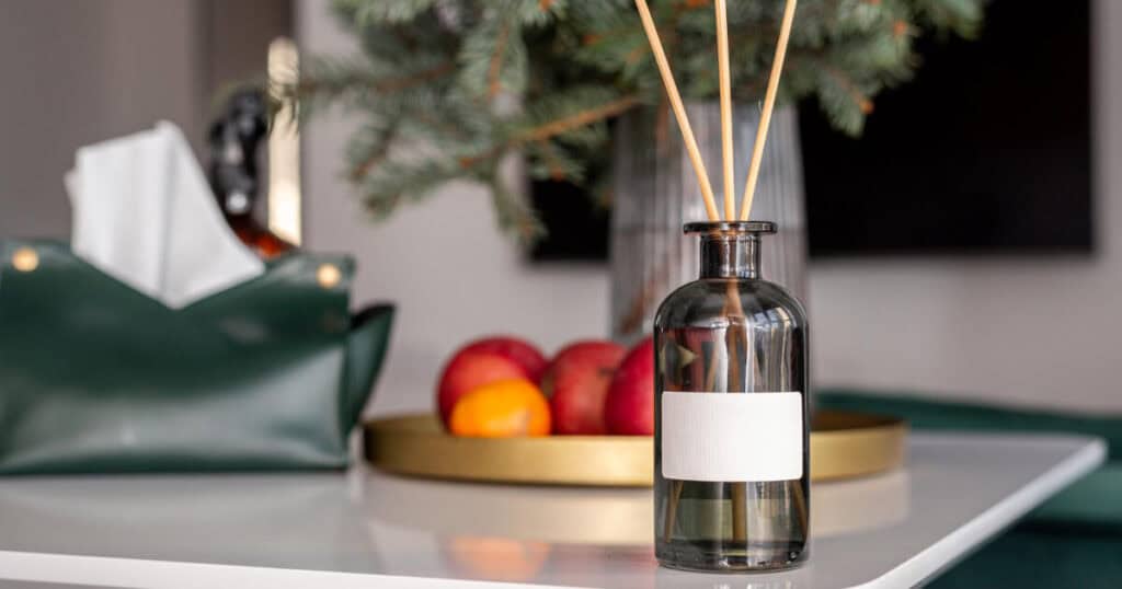 Budget vs Luxury Reed Diffusers: Are Premium Brands Really Worth It? 24 clear bottle of reed diffuser in the kitchen table with fruits