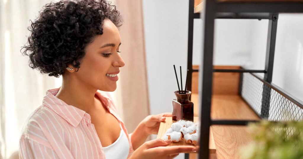 Budget vs Luxury Reed Diffusers: Are Premium Brands Really Worth It? 21 woman holding a tray with reed diffuser and cotton