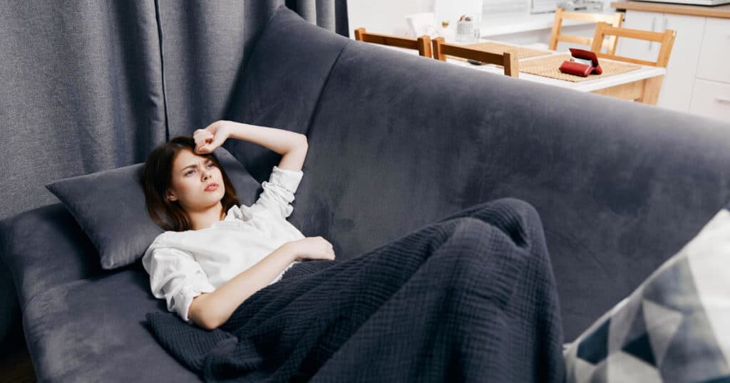 10 Best Linen Sprays to Freshen Your Sofa, Curtains, and Car 10 woman lies on the dark gray sofa